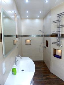 a white bathroom with a sink and a shower at Ferienwohnung Stadtoase in Wittenberg in Lutherstadt Wittenberg
