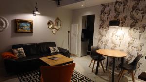 a living room with a couch and a table at Domaine de la Jarrige in Saint-Vaury