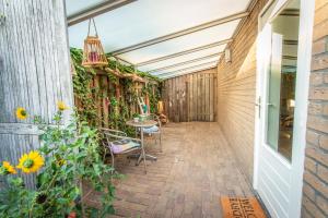 埃因霍温Eindhoven Inn的带桌椅和植物的露台