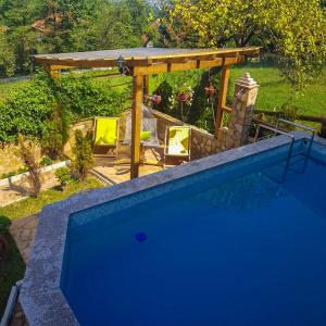 a swimming pool in a yard with a gazebo at Apartment Little Paradise in Visoko
