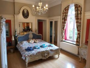 a bedroom with a large bed and a large window at Château Lambert Hotel-Resto-Parking-Shuttle, a 1 ha green Oasis at 8 min from CRL Airport without any noise in Charleroi