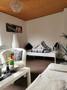 a living room with two beds and a couch at Apartments Lindenstraße in Wilhelmshaven