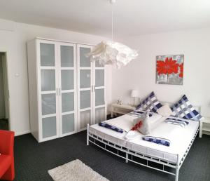 a bedroom with a bed and a cabinet at Apartments Lindenstraße in Wilhelmshaven