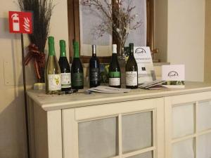 a bunch of wine bottles sitting on top of a table at Agriturismo Crodi in Miane