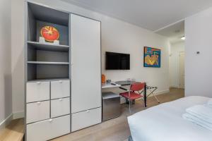 a bedroom with a large white closet with a desk at The Old Lady in Amsterdam