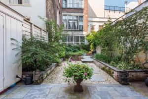 a garden in the side of a building with flowers at The Old Lady in Amsterdam