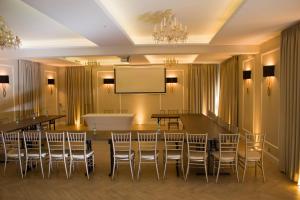 a conference room with chairs and a projection screen at Hudson in Koszalin