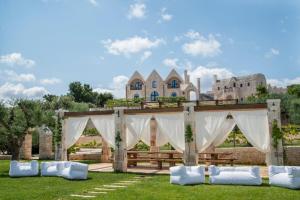 a wedding ceremony set up in front of a castle at Ottolire Resort in Locorotondo