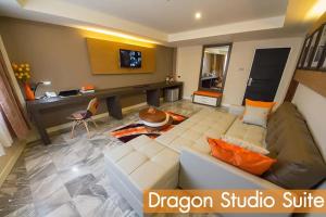 ein Wohnzimmer mit einem Sofa und einem Schreibtisch in der Unterkunft Dragon River Avenue in Phitsanulok