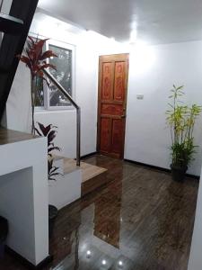 a room with a staircase and a door and plants at NVH3 Coron Palawan in Coron +2 photos