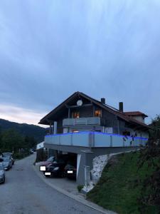 a house on a hill with cars parked in front of it at Appartement/Ferienwohnung in Grafling