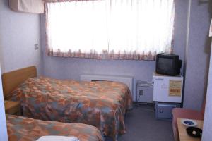 Postel nebo postele na pokoji v ubytování Akakura Wakui Hotel