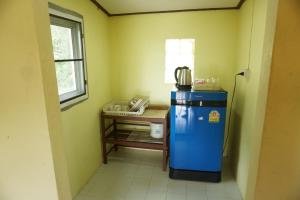 a small kitchen with a blue refrigerator and a table at Mookanda bungalow in Ko Yao Noi +69 photos