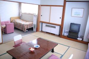 Postel nebo postele na pokoji v ubytování Akakura Wakui Hotel