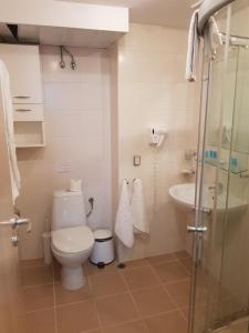 a bathroom with a toilet and a sink at Obzor Beach Resort Exclusive sea view apartment in Obzor +7 photos