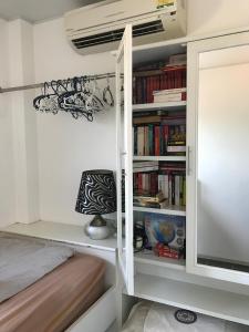 a room with a book shelf with books at Mae Phim -Beachfront living in a villa with a private pool ! in Ban Tha Fat