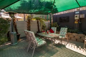 a patio with a table and chairs under a tent at Lala Dene Lodge in Bloemfontein