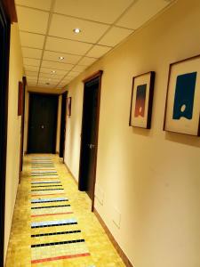 a hallway with a rug on the floor at Hotel Della Baia in Portovenere
