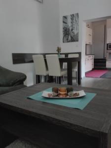 a table with a plate of food on top of it at Centrum Apartman Kukucinova6 in Košice