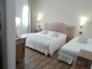 Postel nebo postele na pokoji v ubytování Hotel Antico Mulino