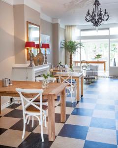
a large kitchen with a large table and chairs at Hotel Gevers in Scheveningen
