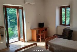 Pratella的住宿－Vista sul Lete，客房设有一张床、一张书桌和窗户。