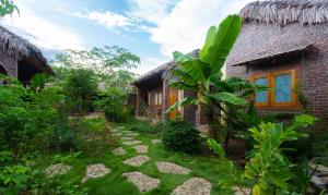 a house with a garden in front of it at Ninh Binh Palm Homestay in Ninh Binh