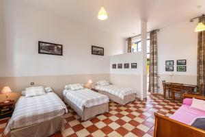 a room with two beds and a table and chairs at Le DOMAINE DES ECOLIERS B&B in Montaigu-Vendée +43 photos