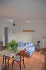 a living room with a bed and a table with chairs at La terraza in Banyoles +40 photos