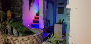 a room with purple and blue lights on the stairs at Jagat Villa Guest House in Udaipur