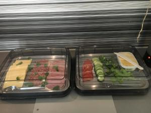 two plastic containers of food with meat and vegetables at Öregrund BnB in Öregrund
