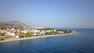 a town on a beach in the water at SgS Luxury Apartments in Xylokastron