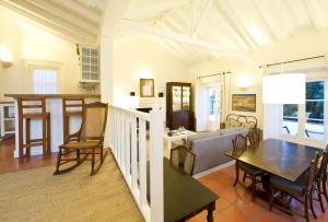 a kitchen and living room with a table and chairs at Quinta Da Cabrita in Santarém