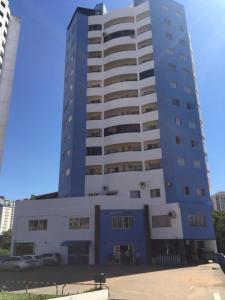 a blue and white building with cars parked in front of it at Cond. Golden Thermas Residence - Shapphire Tower in Caldas Novas +13 photos