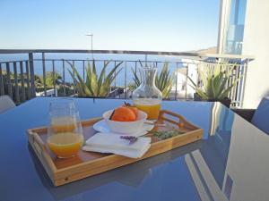 a tray of oranges and juice on a table on a balcony at Villa Boutique La Quinta in Santa Úrsula