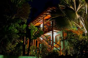 a house with a staircase leading up to it at night at Casa Ka in Maresias