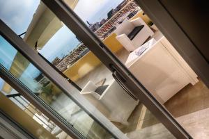 a view through a sliding glass door of a living room at La terrazza dei colori in Gaeta