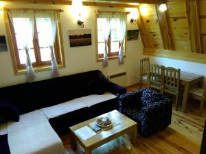 a living room with a couch and a table at Mountain House Tadić 1 in Bajina Bašta