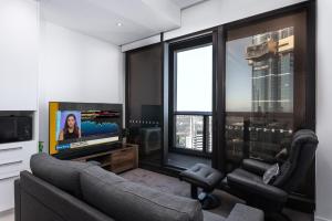 a living room with a couch and a flat screen tv at Prima 4511 in Melbourne