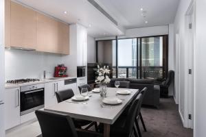 a kitchen and dining room with a table and chairs at Prima 4511 in Melbourne