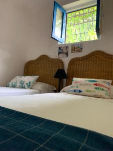 a bedroom with two beds and a window at Casa delle Galee in Scilla