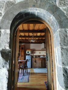 an archway leading into a kitchen with a table and a dining room at Hye Aspet Հայ Ասպետ in Gyumri