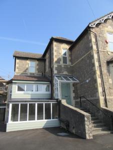 a brick house with a stairway leading to a door at Central Living Apartment in Weston-super-Mare