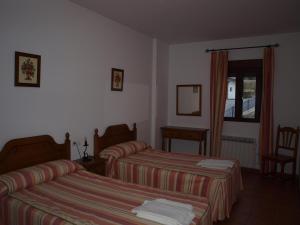 Postel nebo postele na pokoji v ubytování Apartamentos El Mirador