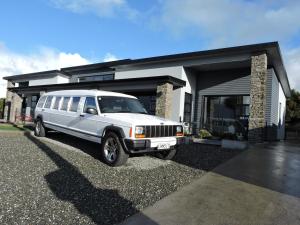 a white limo parked in front of a house at The Reservation B&B in Gore