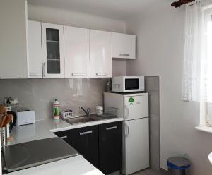 Kuchyň nebo kuchyňský kout v ubytování Apartament MARGARITA