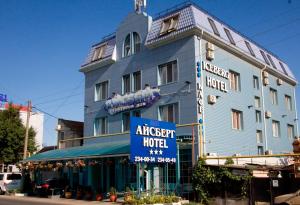 a large blue building with a sign on it at Iceberg Hotel in Krasnodar