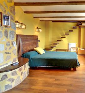 a bedroom with a bed and a staircase at Casa Rural Mirador del Salto in Chella