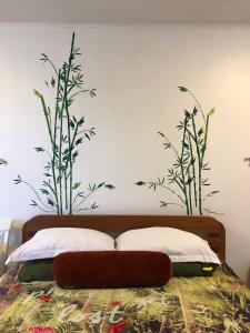 a bed that has a plant in it at Holland Lodge Paramaribo in Paramaribo