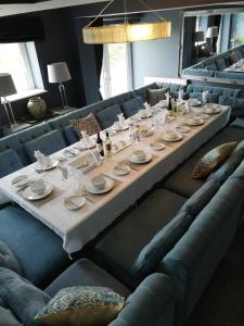 a long table in a room with couches at Ocean View,Kinsale, Exquisite holiday homes, sleeps 22 in Kinsale